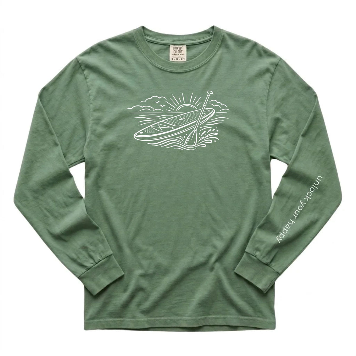 Unlock Your Happy paddleboard long sleeve shirt featuring a white paddleboard and sunrise graphic on a light green  Comfort Colors tee