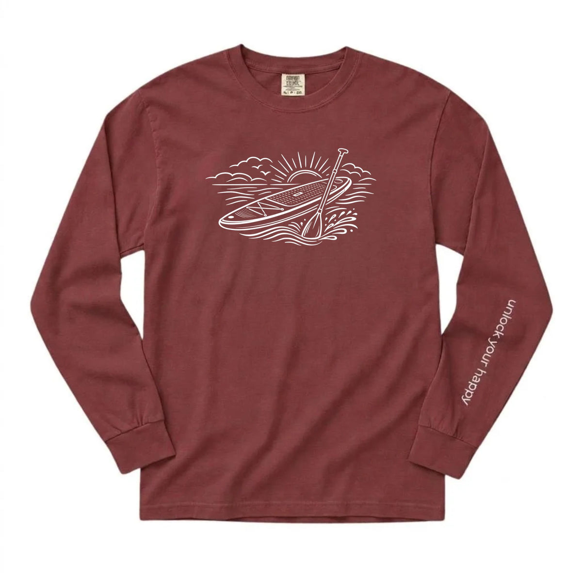 Unlock Your Happy paddleboard long sleeve shirt featuring a white paddleboard and sunrise graphic on a brick red Comfort Colors tee