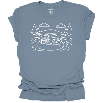 Nature Heals river tubing graphic blue t-shirt with minimalist outdoor water and tree line art design