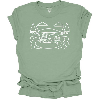 Nature Heals river tubing graphic sage t-shirt with minimalist outdoor water and tree line art design