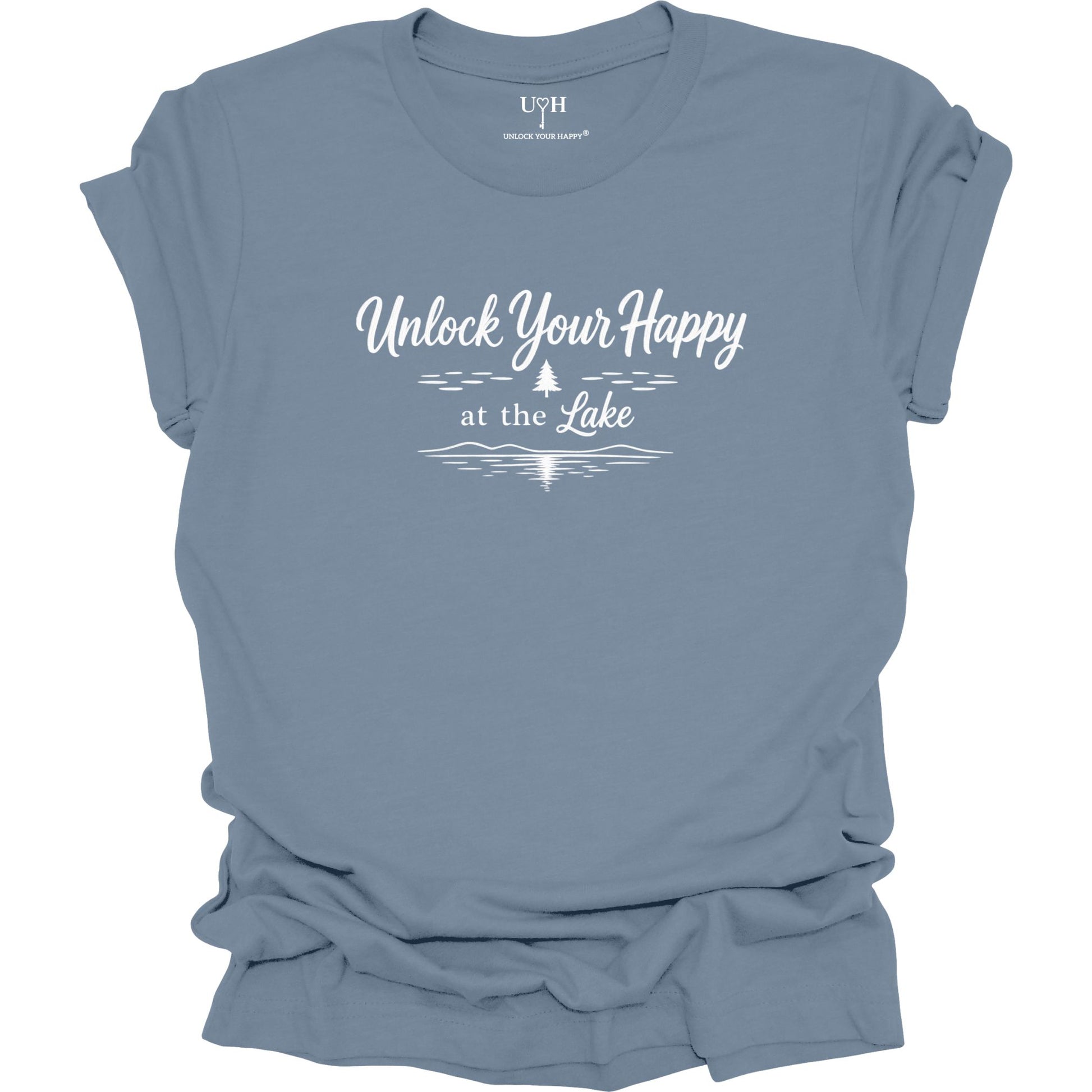 A blue short-sleeve t-shirt with a white graphic print that reads 'Unlock Your Happy at the Lake' above a simple pine tree and lake wave silhouette. The shirt is shown flat with a slightly rumpled drape, and the brand name 'UYH' is visible inside the collar.