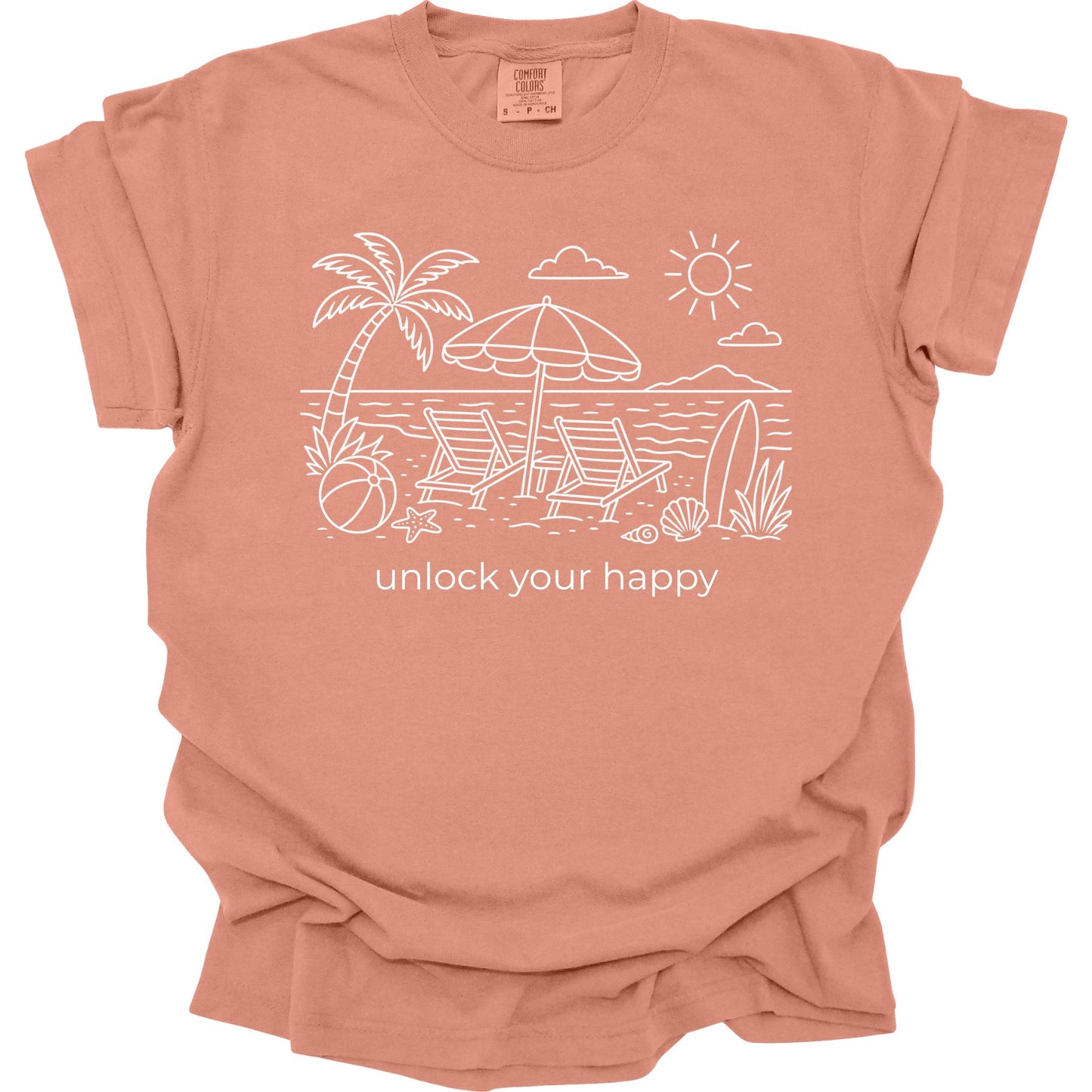 Terracotta colored  t-shirt with beach graphic and 'unlock your happy' text on a white background