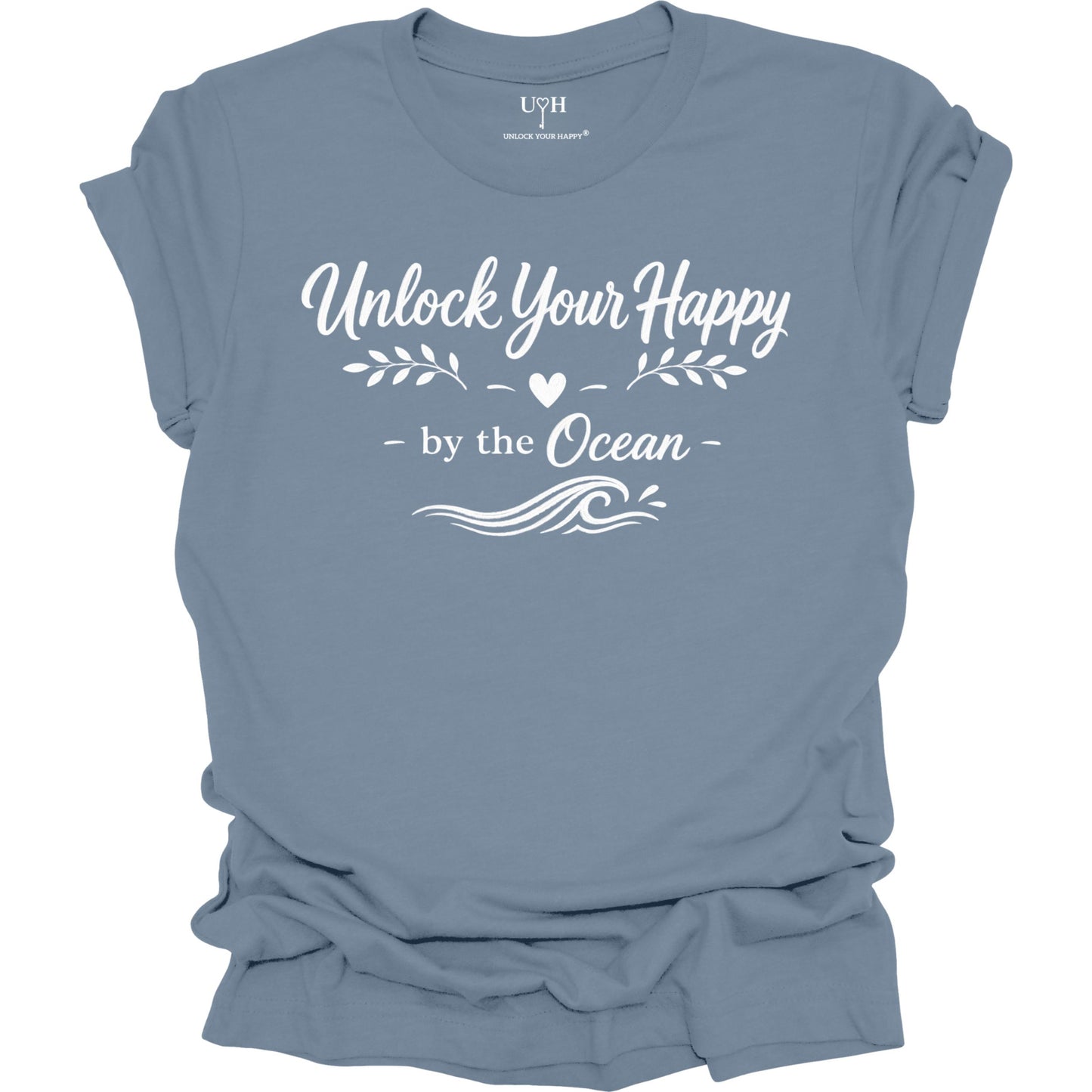 Blue t-shirt with white text 'Unlock Your Happy by the Ocean' on a white background