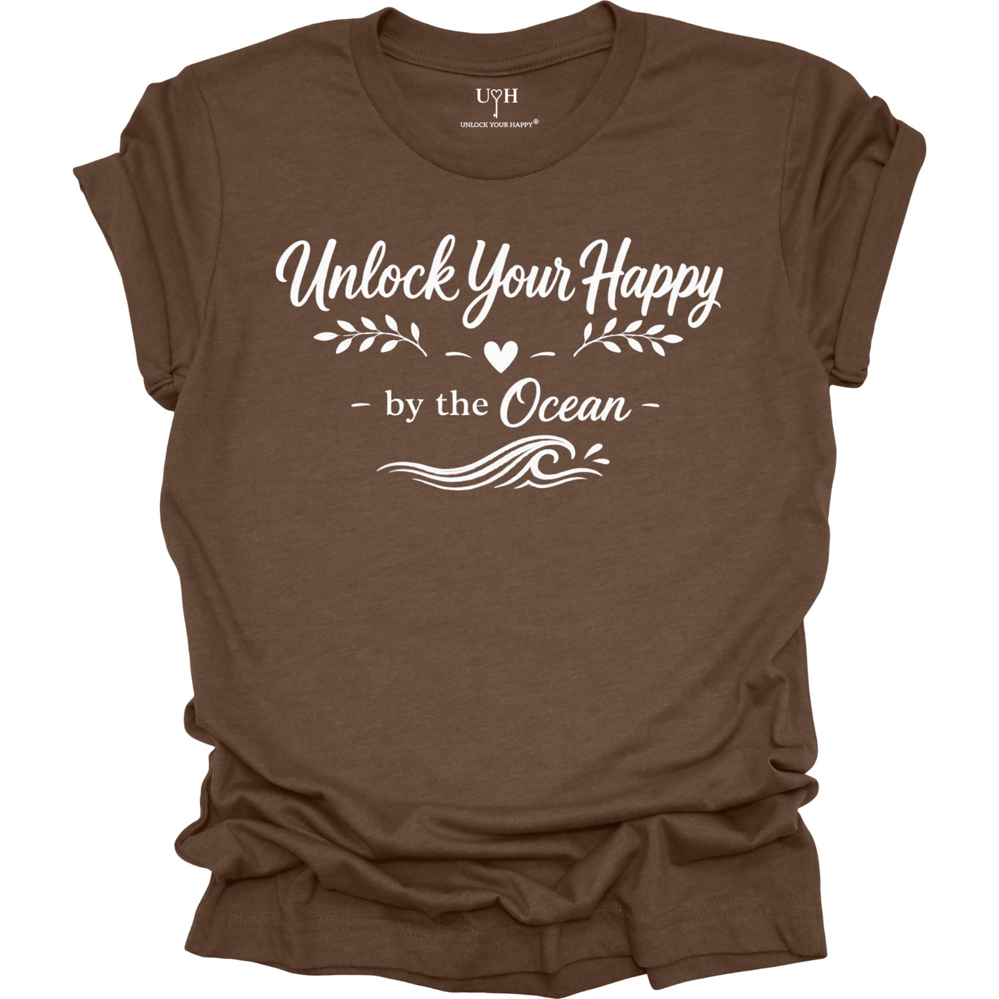 Brown t-shirt with white text 'Unlock Your Happy by the Ocean' on a white background