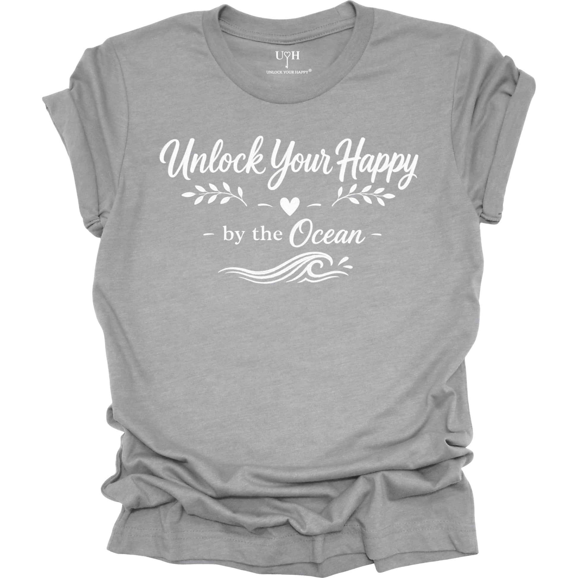 Gray t-shirt with 'Unlock Your Happy by the Ocean' text on a white background