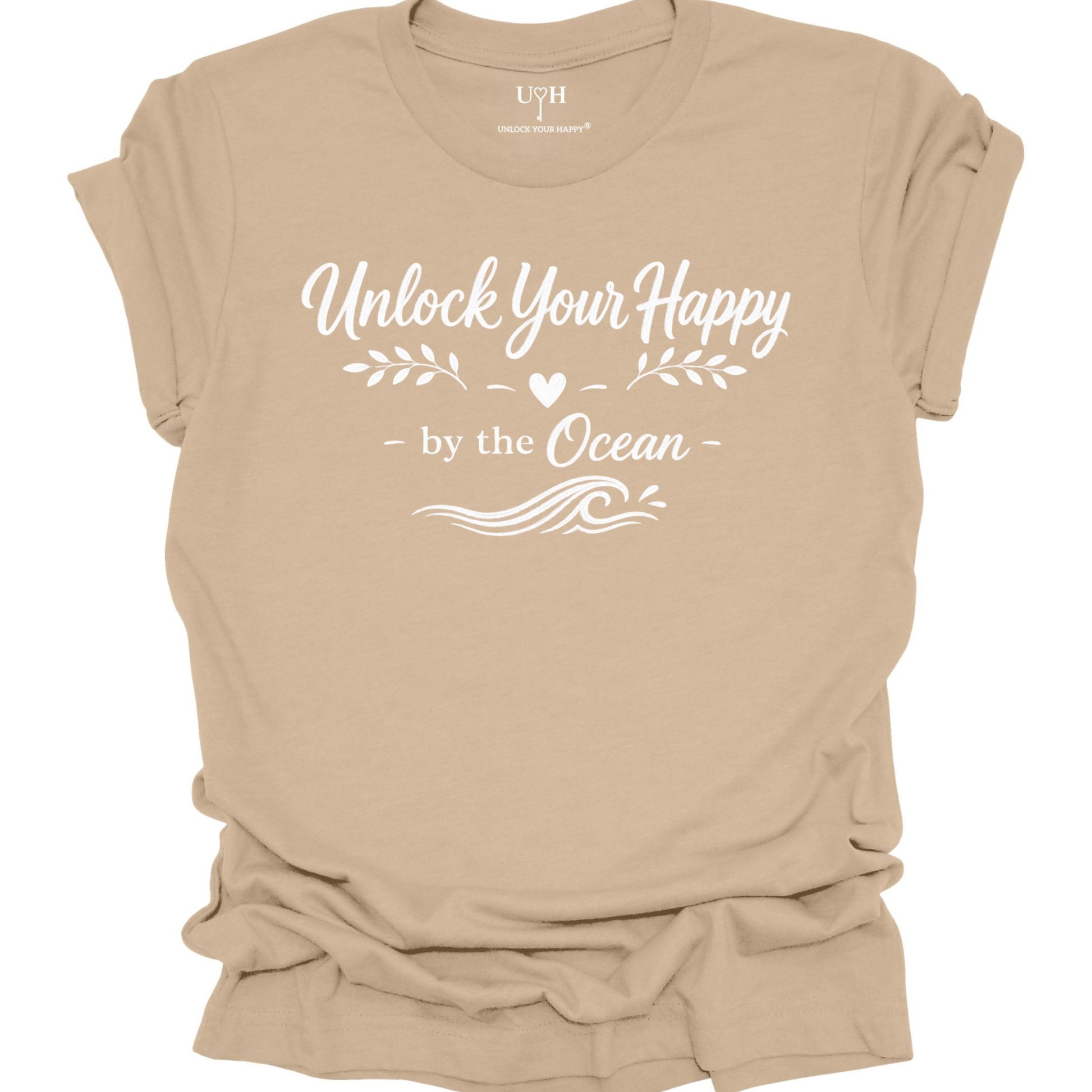 Tan t-shirt with 'Unlock Your Happy by the Ocean' text on a white background