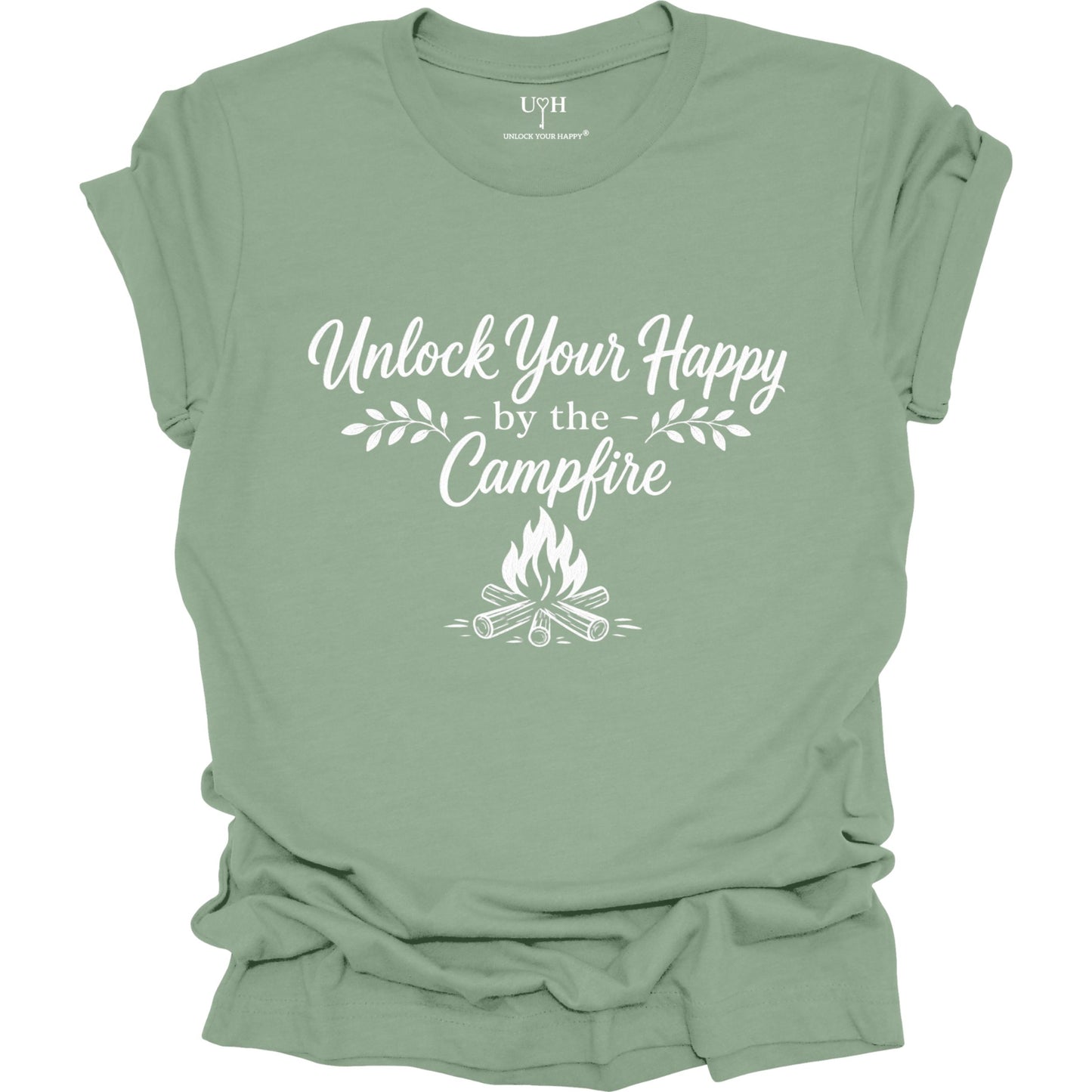 Sage-green t-shirt with 'Unlock Your Happy by the Campfire' text and graphic on a white background