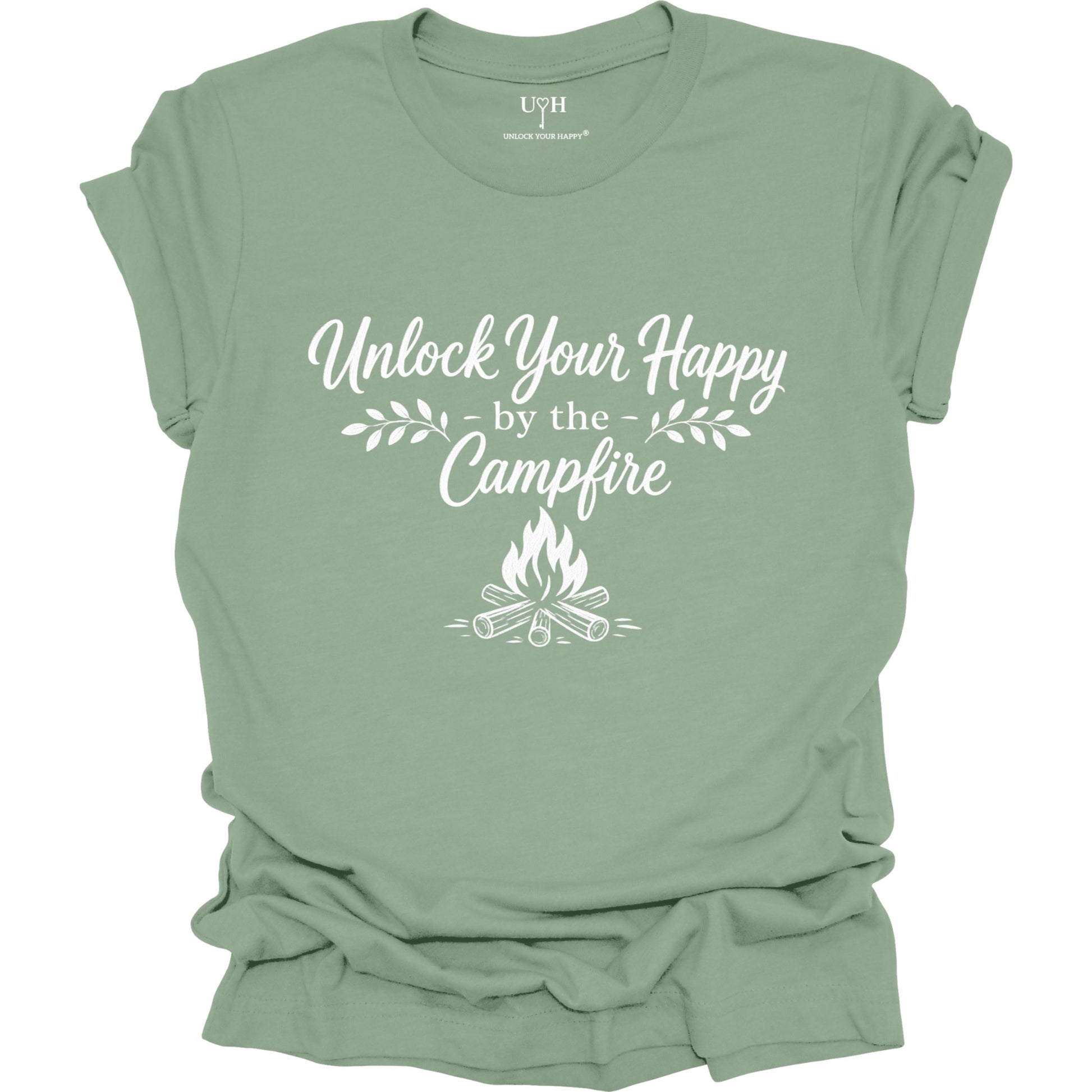 Sage-green t-shirt with 'Unlock Your Happy by the Campfire' text and graphic on a white background