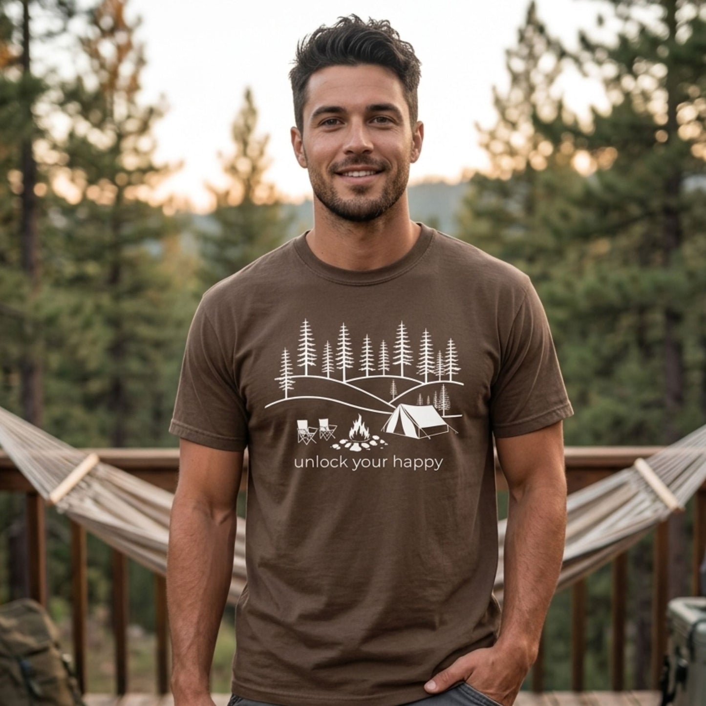 Man wearing a brown t-shirt with a camping graphic and unlock your happy text