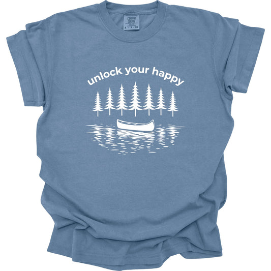 Blue t-shirt with white graphic of trees and a canoe with 'unlock your happy' text on a white background