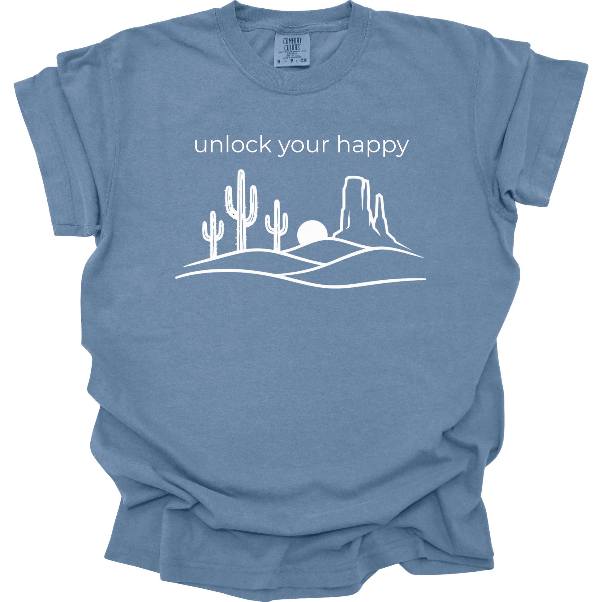 Blue t-shirt with desert graphic and 'unlock your happy' text on a white background