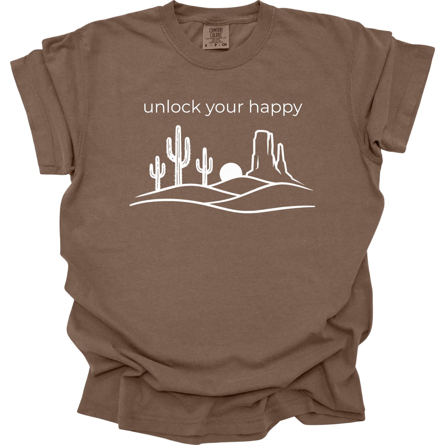 Brown t-shirt with desert graphic and 'unlock your happy' text on a white background