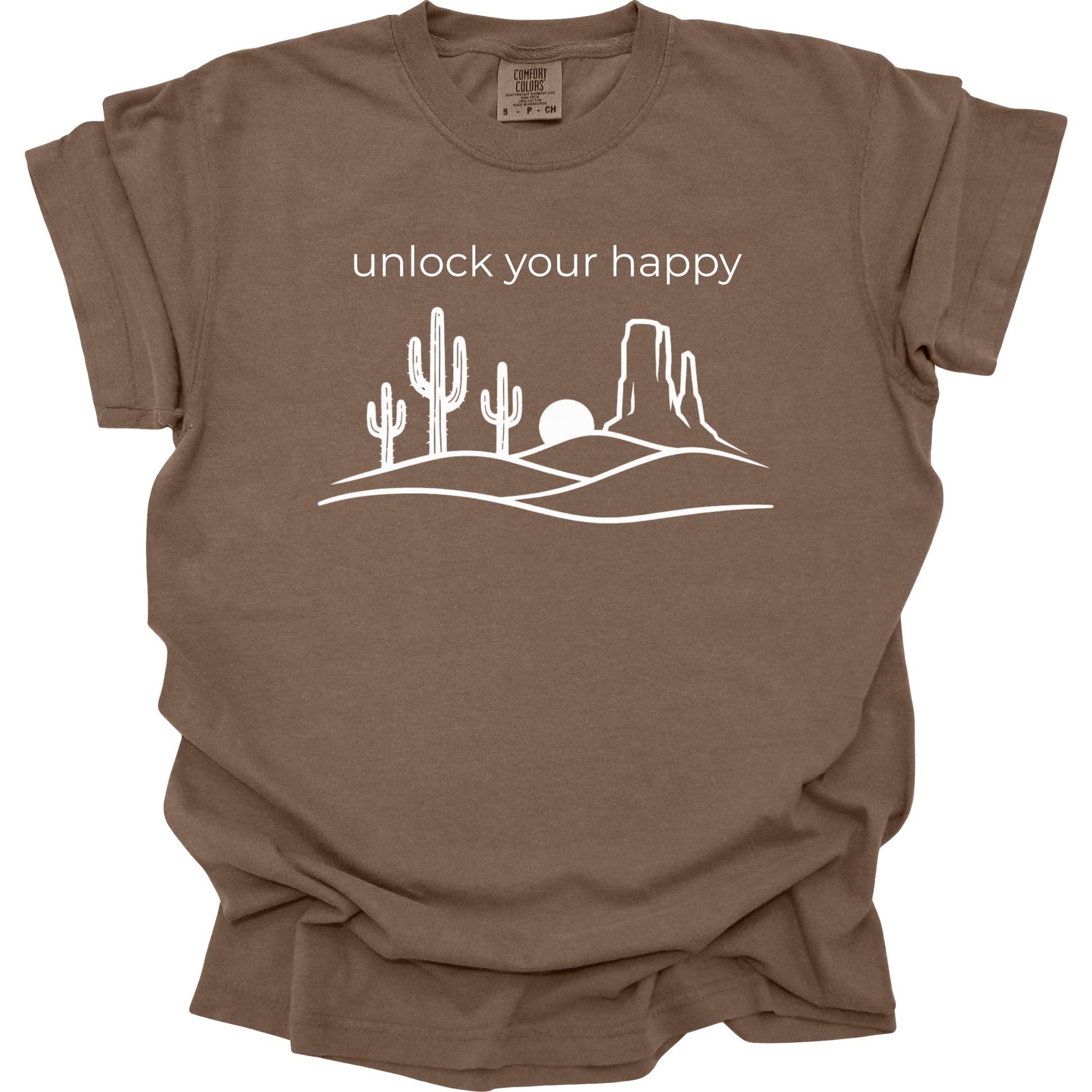 Brown t-shirt with desert graphic and 'unlock your happy' text on a white background