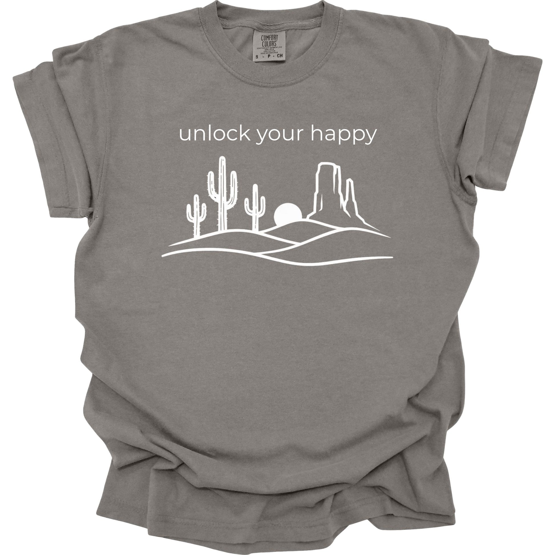 Grey t-shirt with desert graphic and 'unlock your happy' text on a white background