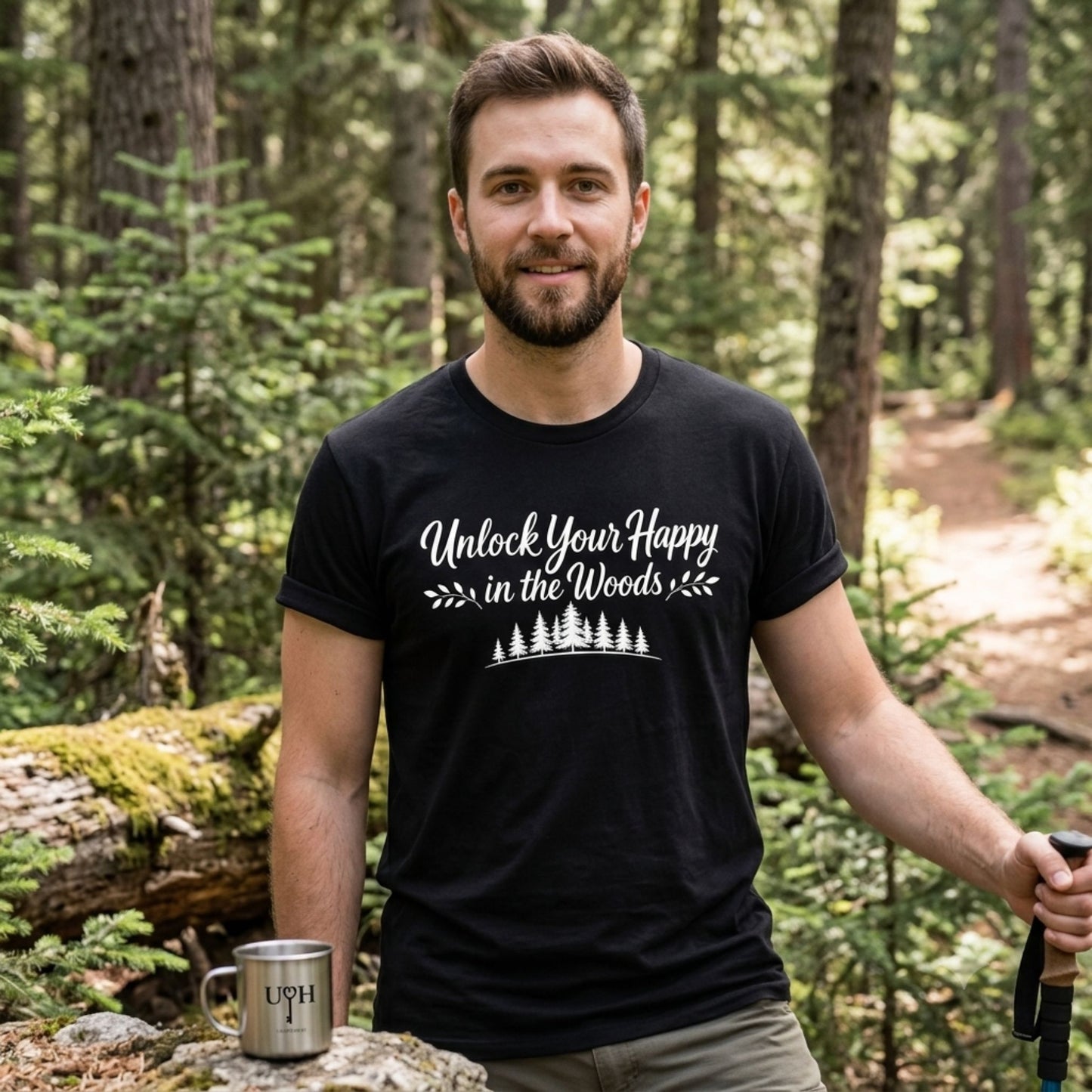 Unlock Your Happy in the Woods White Text with tree line on a black shirt on a male in the woods