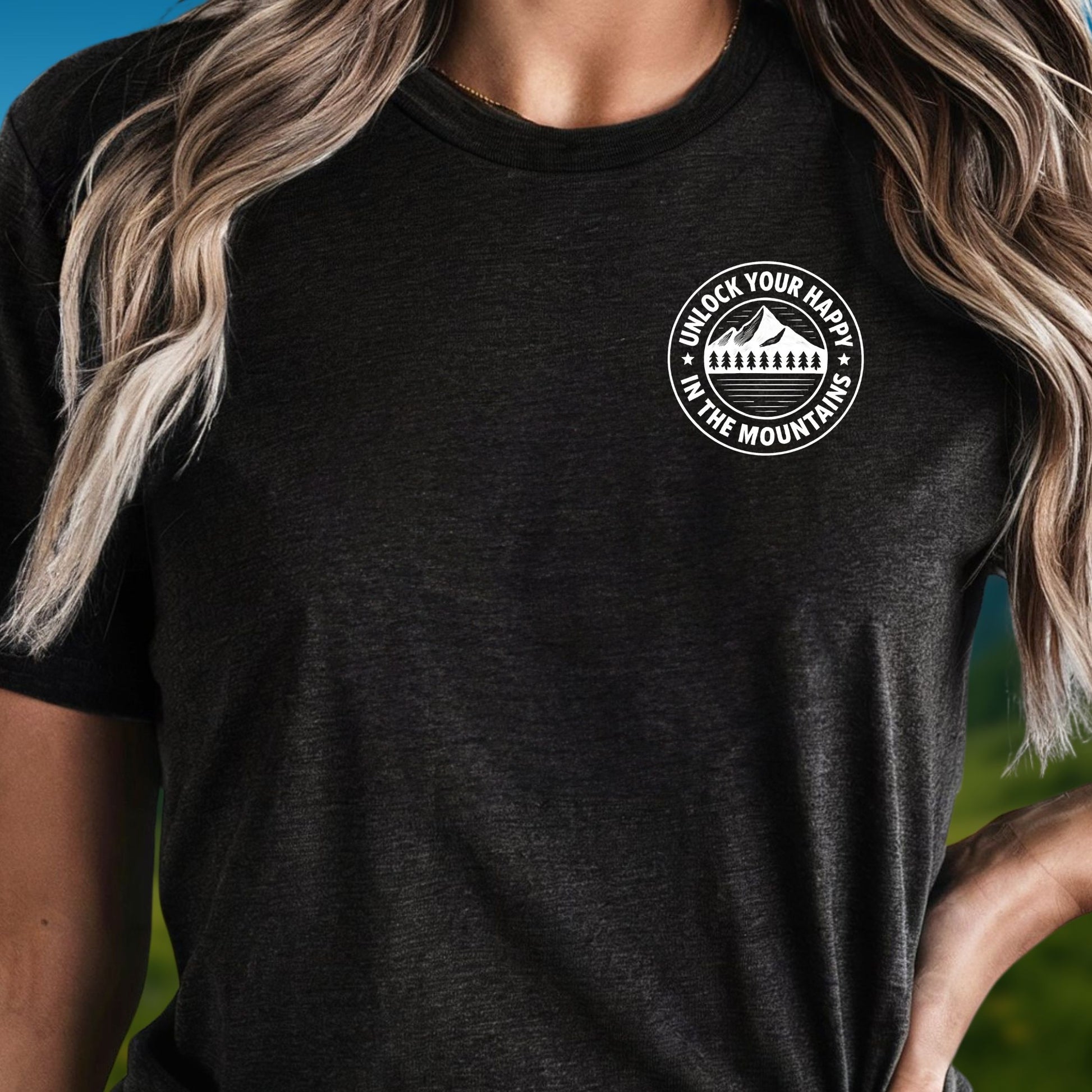 Female wearing a left chest mountain graphic black t-shirt with 'Unlock Your Happy' text  