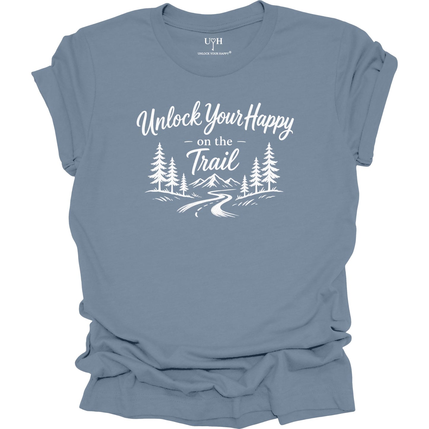 A slate blue short-sleeve t-shirt with a white graphic print on the front that reads 'Unlock Your Happy on the Trail' above a simple pine tree and mountain landscape illustration. The shirt is shown flat against a solid white background, with the collar label showing the brand 'UYH'.