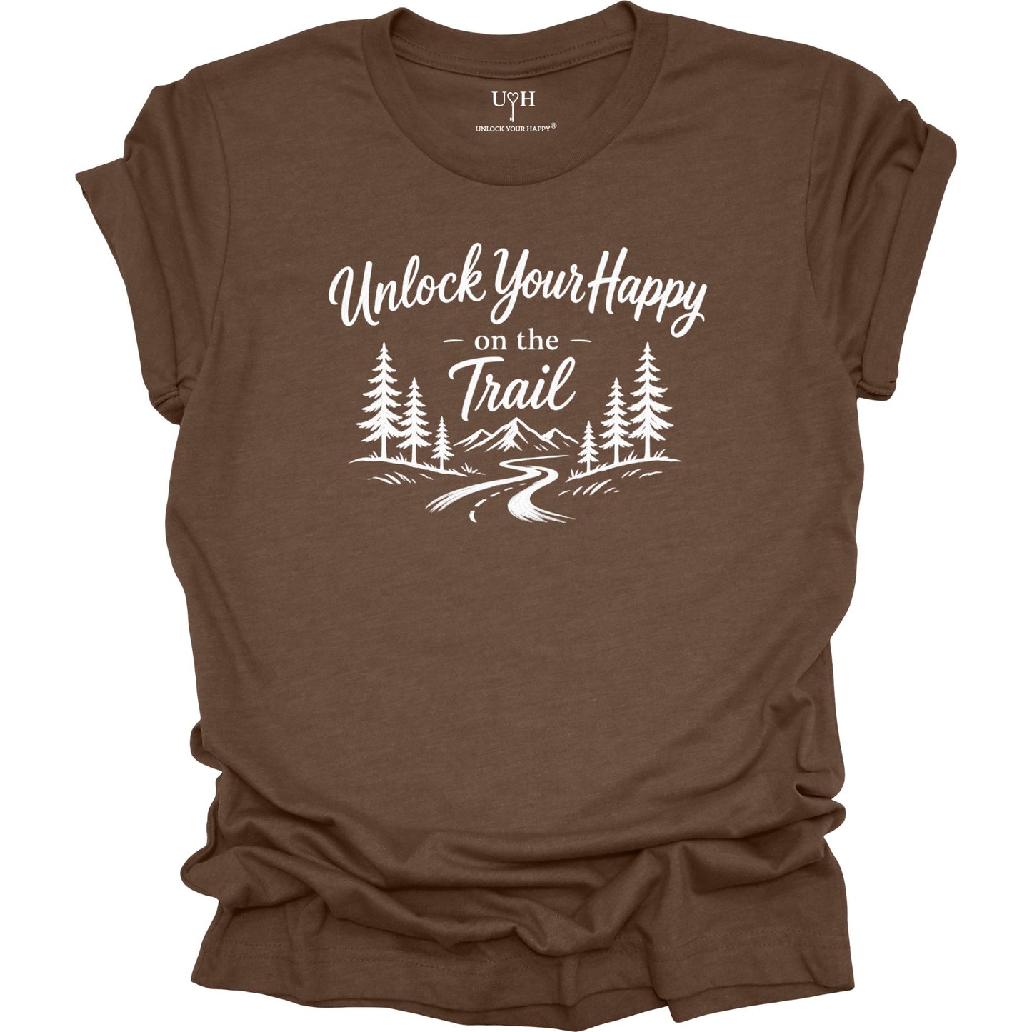 Brown t-shirt with white text Unlock Your Happy on the trail and  line art of a trail in the woods and mountains.
