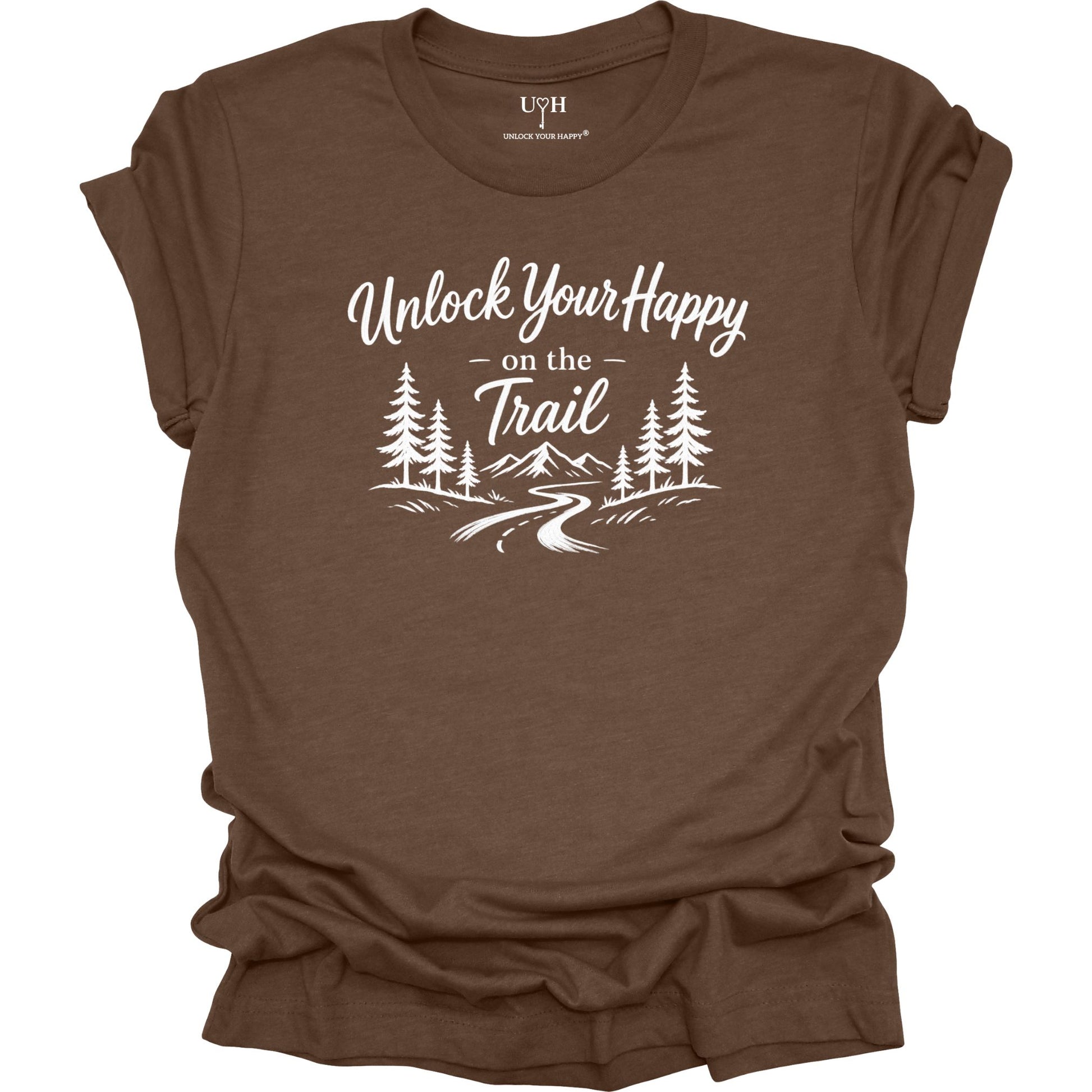 Brown t-shirt with white text Unlock Your Happy on the trail and  line art of a trail in the woods and mountains.