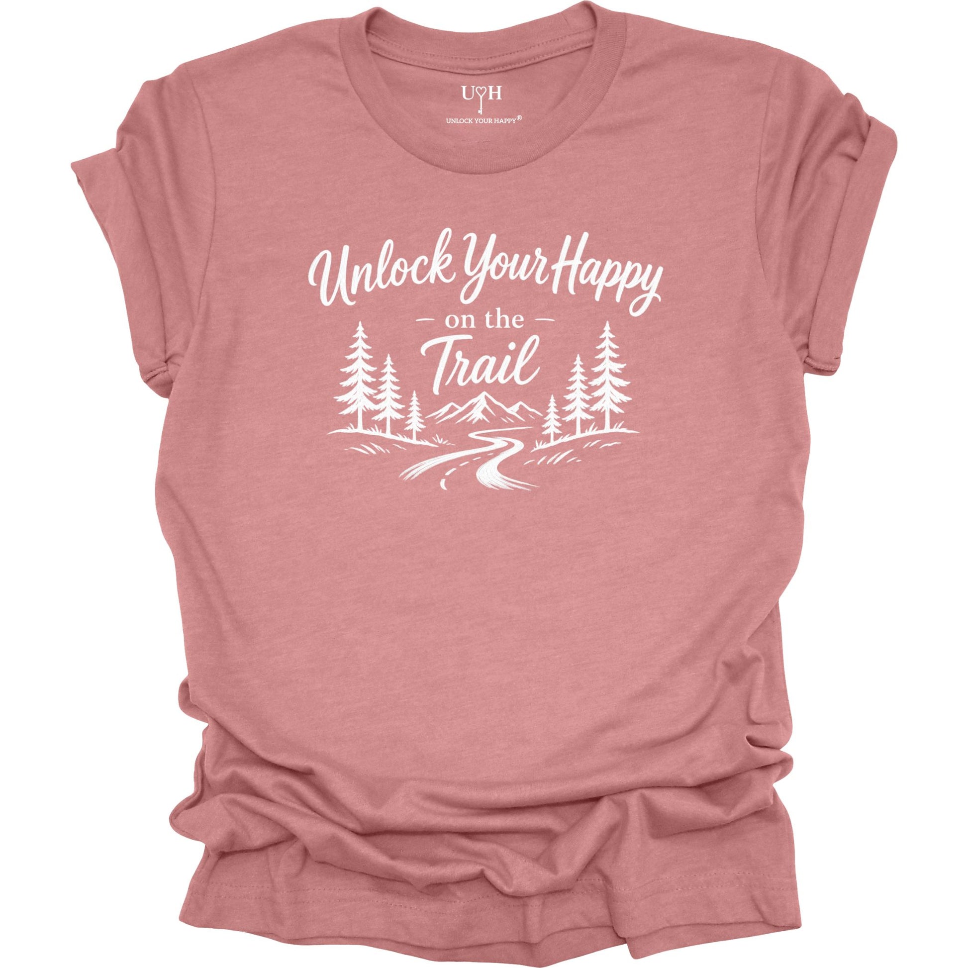 A mauve colored short-sleeve t-shirt with a white graphic print that reads 'Unlock Your Happy on the Trail' above a simple pine tree and trail illustration. The shirt is shown flat against a solid white background, with the brand 'UYH' visible inside the collar.