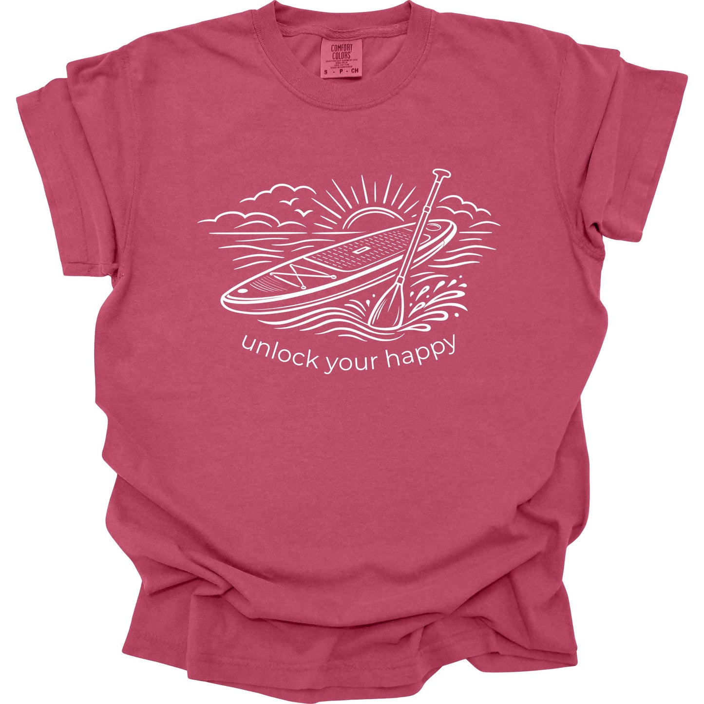 Brick colored t-shirt with paddleboard graphic and 'unlock your happy' text on a white background