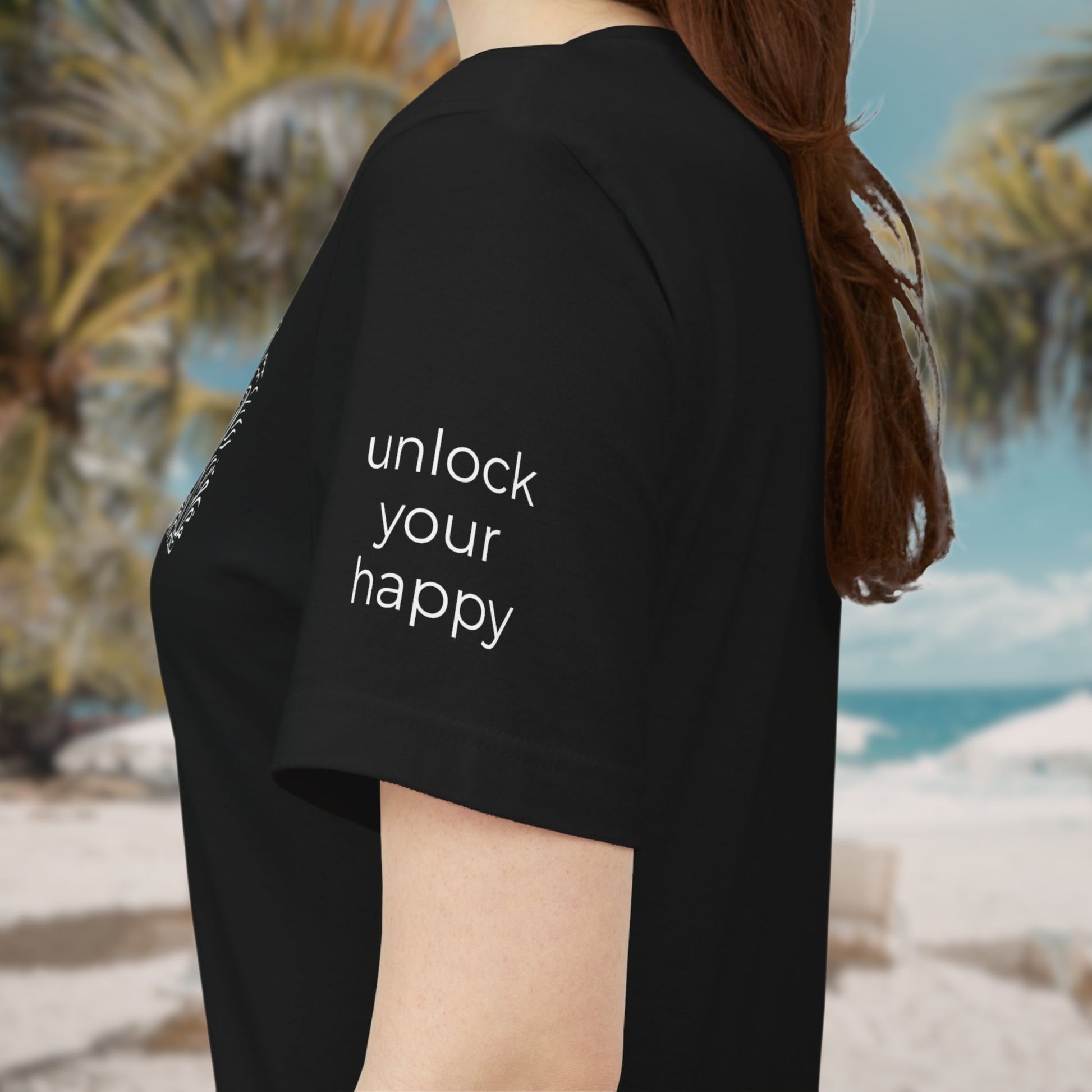 Person wearing a black t-shirt with 'unlock your happy' text on the sleeve.