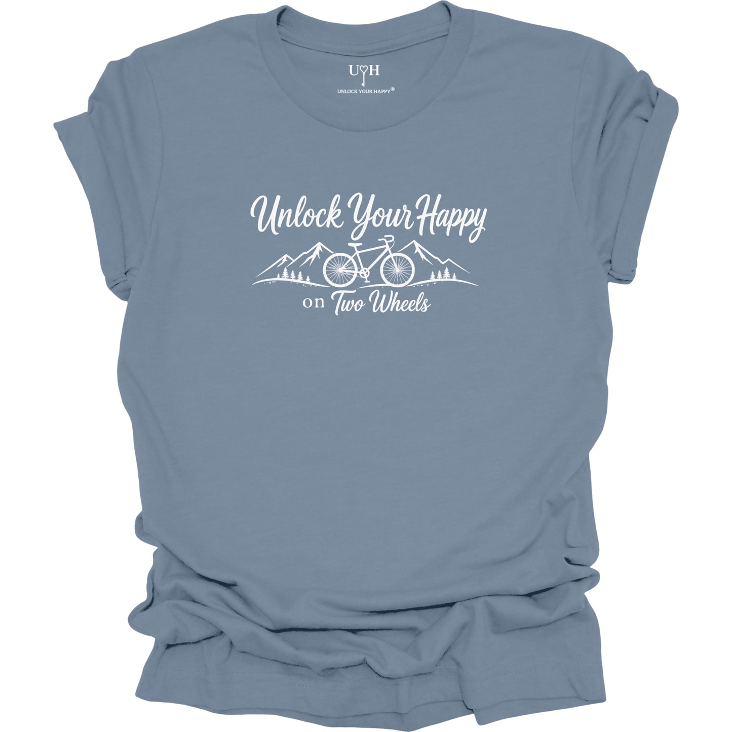A slate blue short-sleeve t-shirt with a white graphic print that reads 'Unlock Your Happy on Two Wheels' above a simple mountain and bicycle illustration. The shirt is shown flat with a slightly distressed or ruffled texture, and the inner collar label shows the brand 'UYH'.