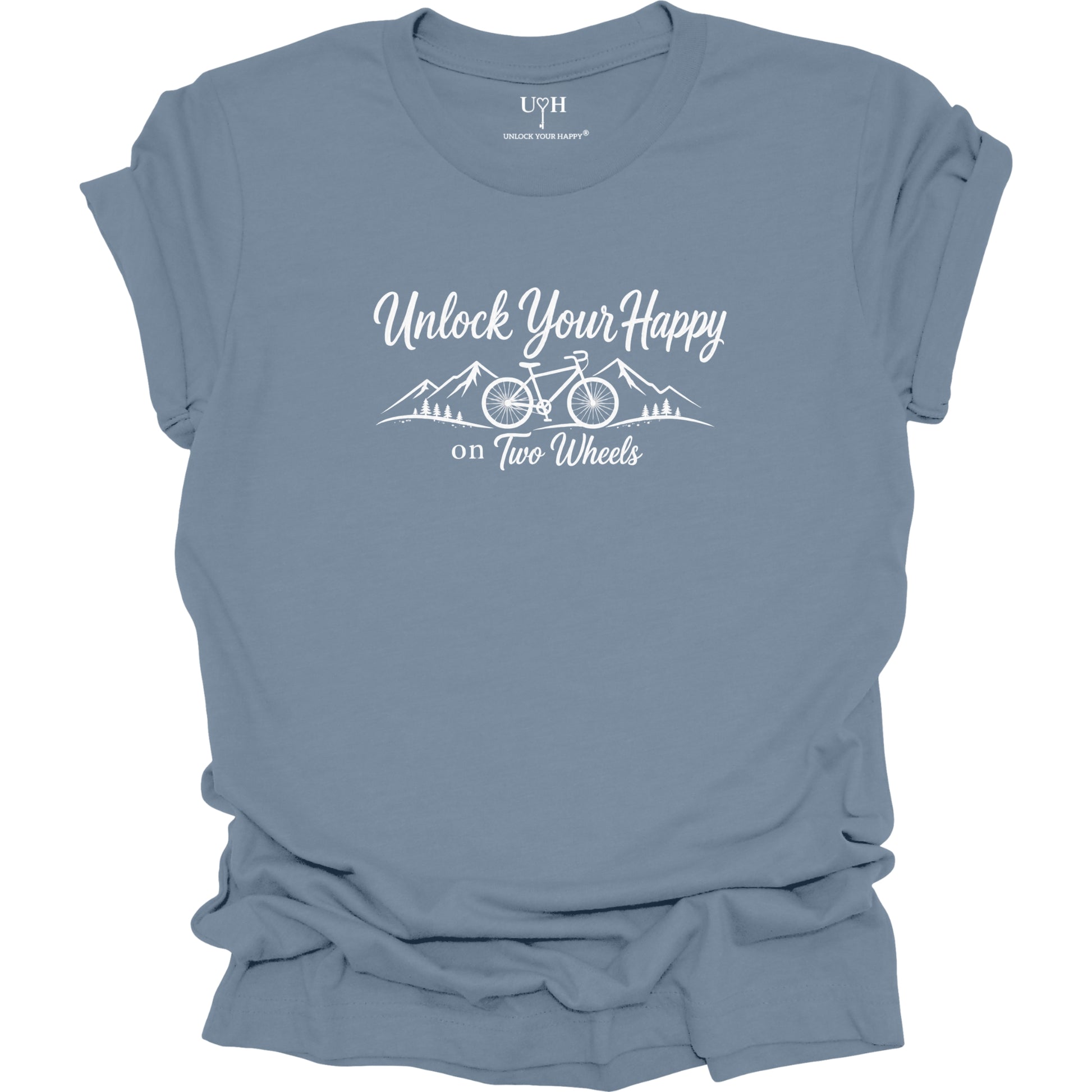 A slate blue short-sleeve t-shirt with a white graphic print that reads 'Unlock Your Happy on Two Wheels' above a simple mountain and bicycle illustration. The shirt is shown flat with a slightly distressed or ruffled texture, and the inner collar label shows the brand 'UYH'.