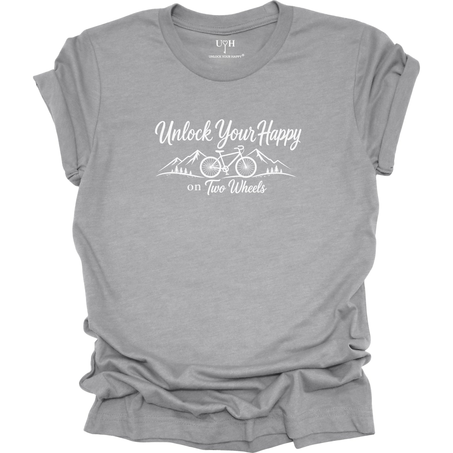 Gray t-shirt with 'Unlock Your Happy on Two Wheels' text and bike and mountain graphic on a white background.