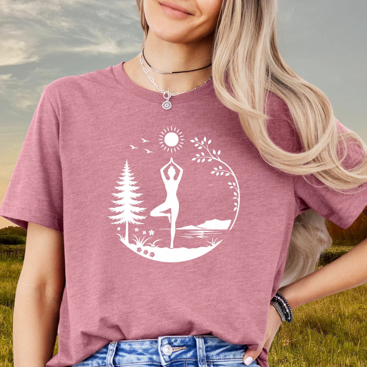 Person wearing a mauve nature yoga tee with “Unlock Your Happy” sleeve detail